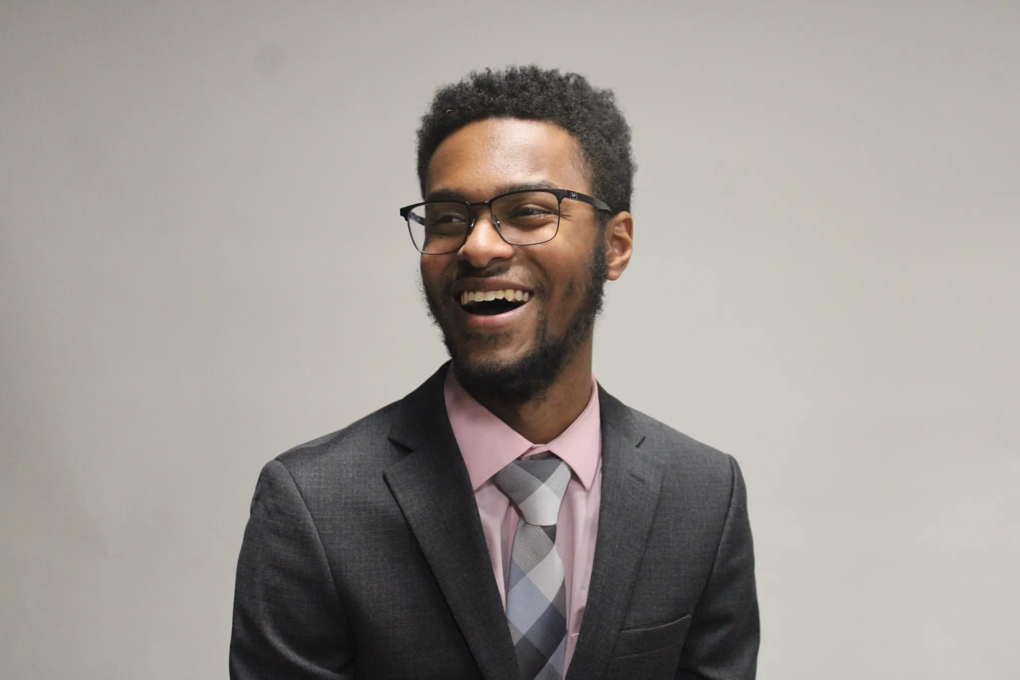 Jordan Warren wearing a suit and smiling